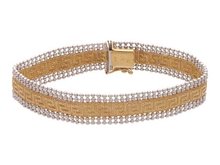 Pulsera hechura italiana motivo grecas en oro dos tonos 14 kilates. Sale